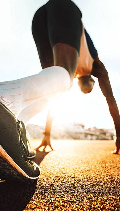 Man in starting position to run in a face