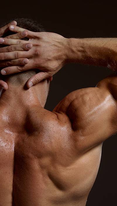 Man flexing shoulders from behind
