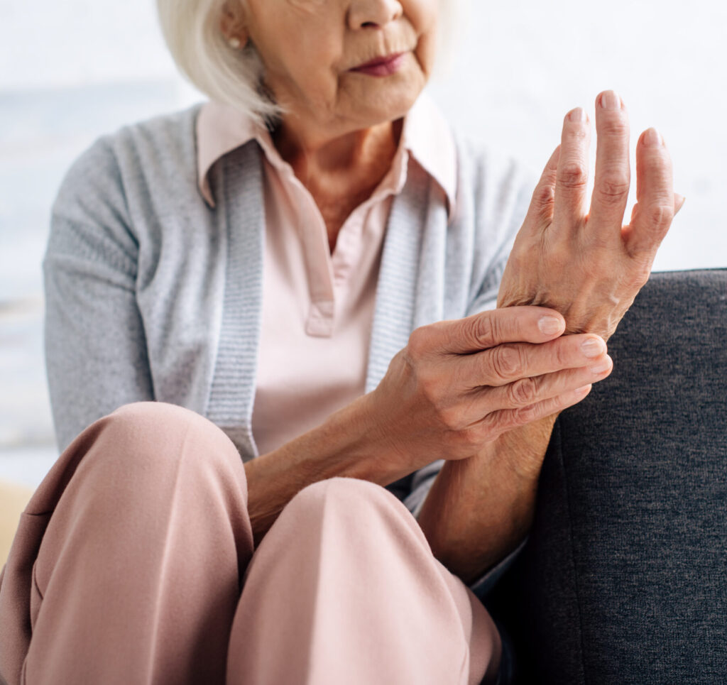 elderly woman with arthritis pain in hand