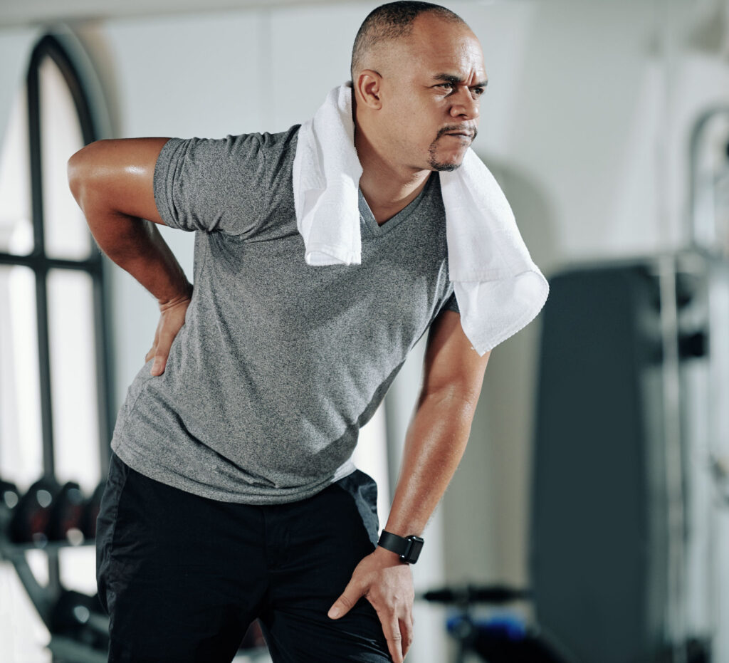 Man at gym with back pain