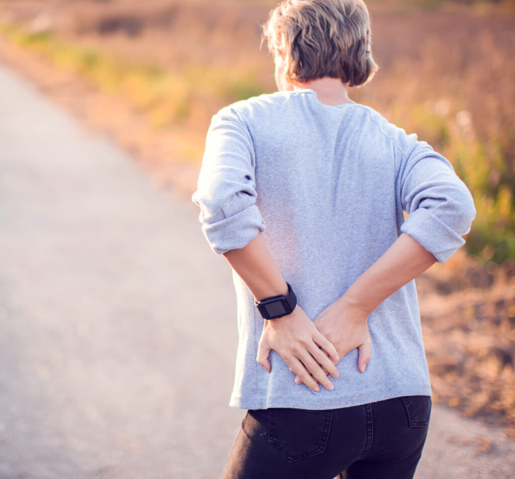 Woman walking outdoor with hip pain