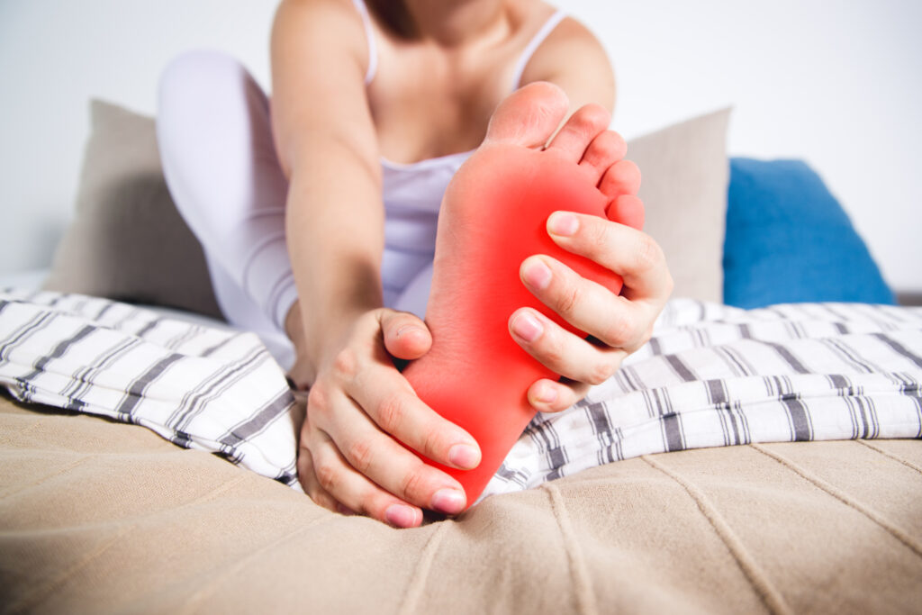 Woman holding foot suffering from neuropathy pain