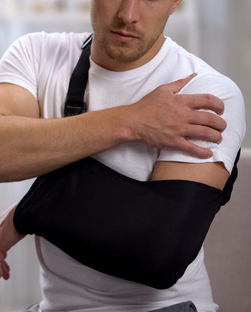 man in arm sling from car accident injury