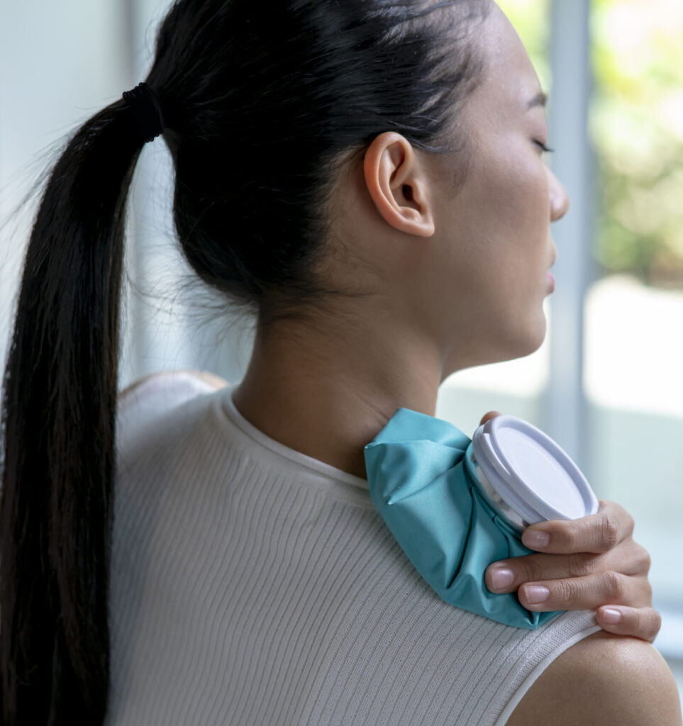 Woman icing her shoulder because of pain