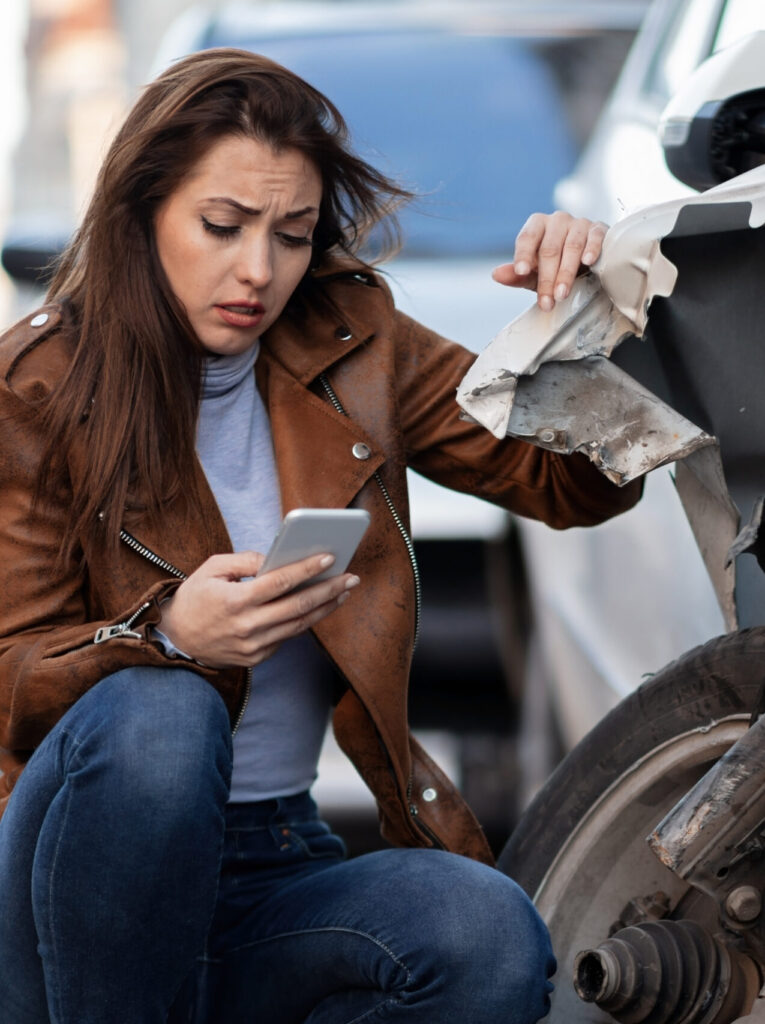 Woman next to car accident calling for help